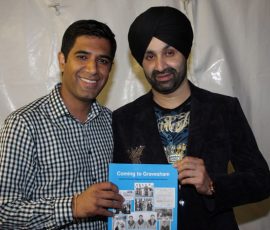 Gurvinder Sandher presenting copy of Coming to Gravesham to Sukshinder Shinda