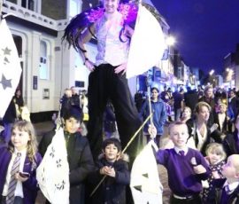 Pupils from Our Lady Hartley School with Will the Stilt Walker